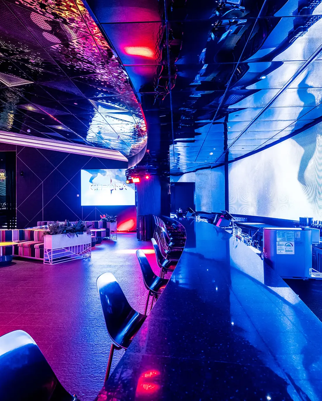 Blue-lit lounge and DJ area at Chroma